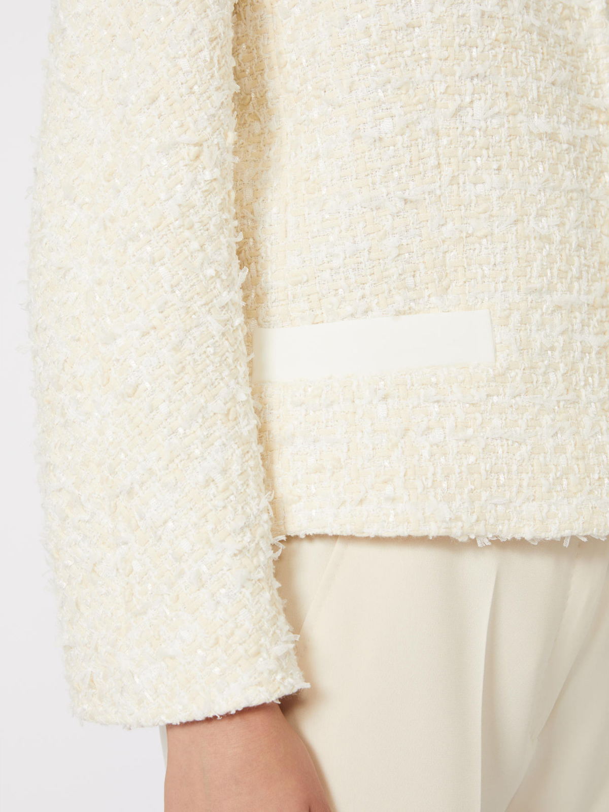 Close-up of a textured white jacket with a plain background