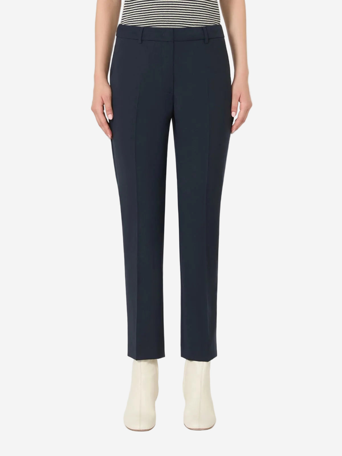 Navy blue pants worn by a person on a white background