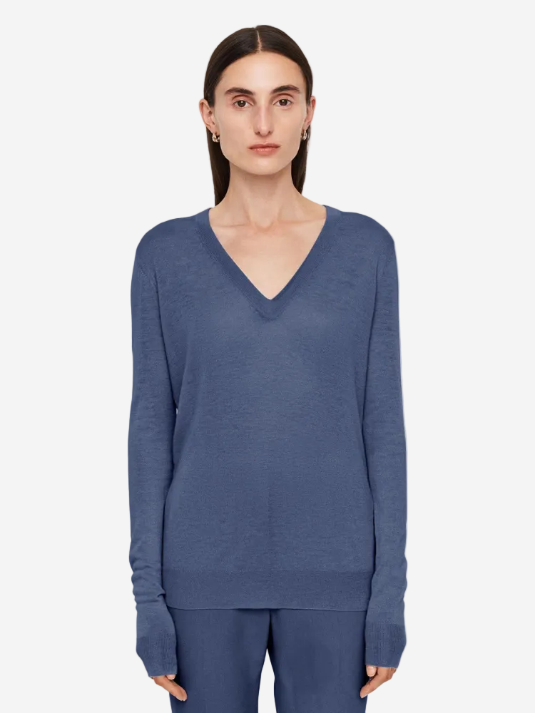 Woman wearing a blue sweater on a white background