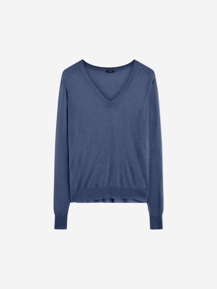 A blue Cashair V-neck long-sleeved sweater on a plain background.