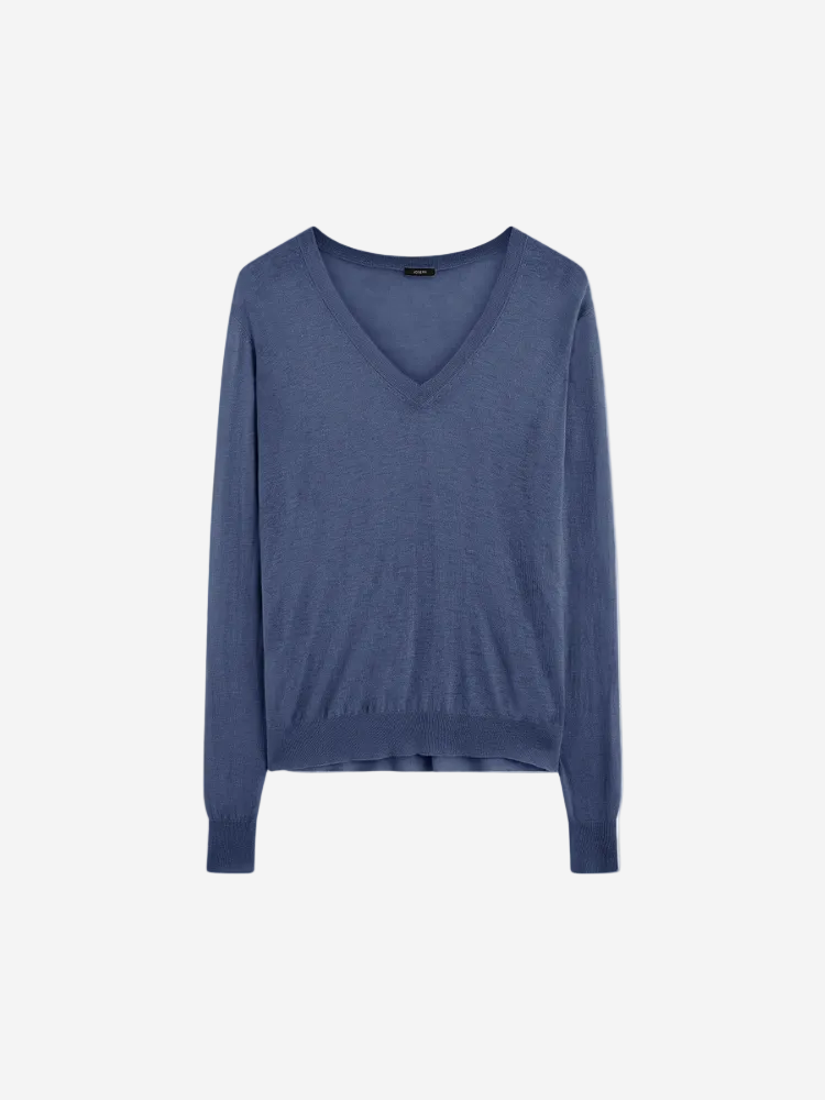 A blue Cashair V-neck long-sleeved sweater on a plain background.