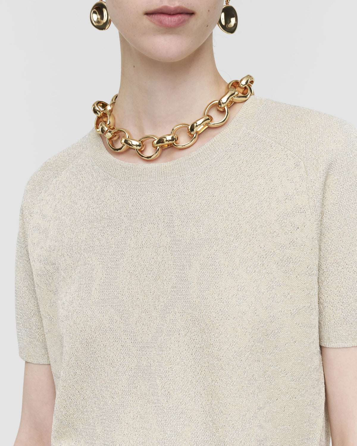 Close-up of the ribbed crew neck and champagne metallic knit on the JOSEPH Char top