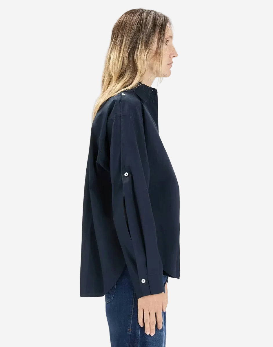 Woman wearing a navy blue jacket on a white background