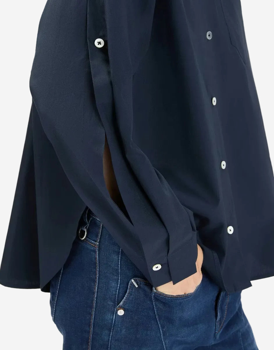 Navy blue shirt with white buttons and blue jeans on a white background