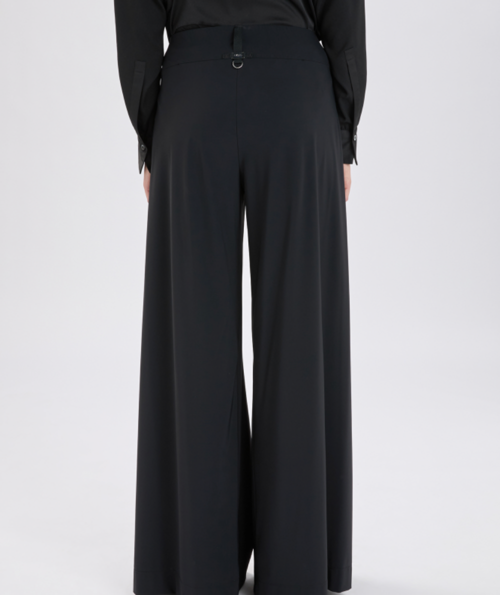Black wide-leg pants worn by a person on a white background