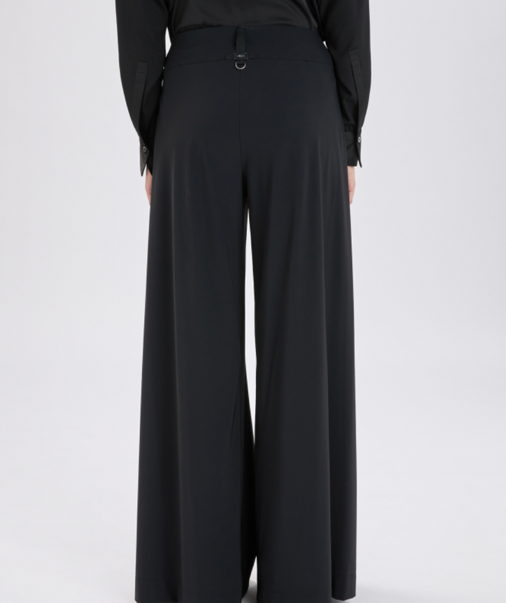 Black wide-leg pants worn by a person on a white background