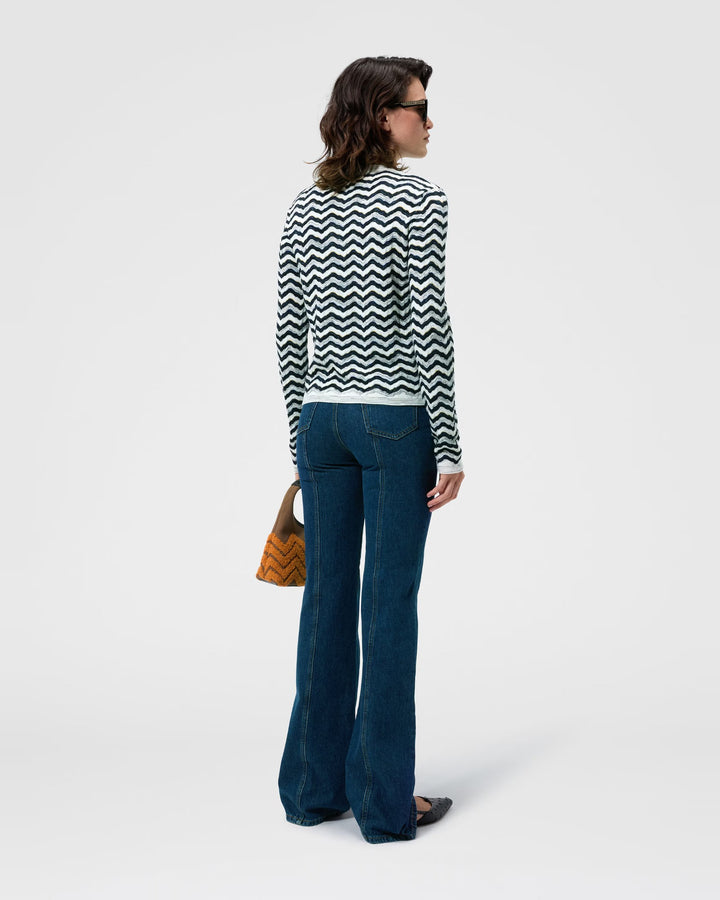 Back view of the Missoni navy and white wave knit cardigan worn with flared jeans