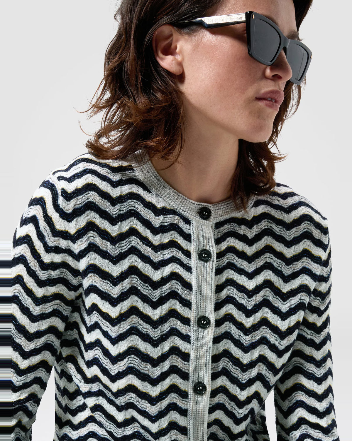 Close-up of the Missoni wave motif knit and contrast button placket on the navy and white cardigan