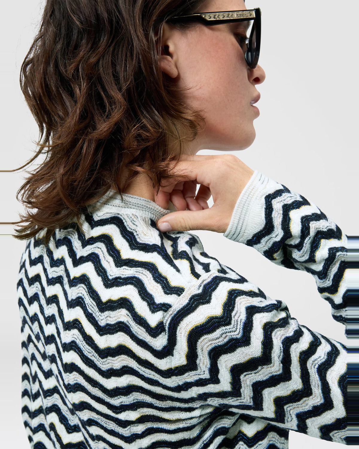 Detail of the Missoni zigzag knit across the shoulder and sleeve of the navy and white cardigan