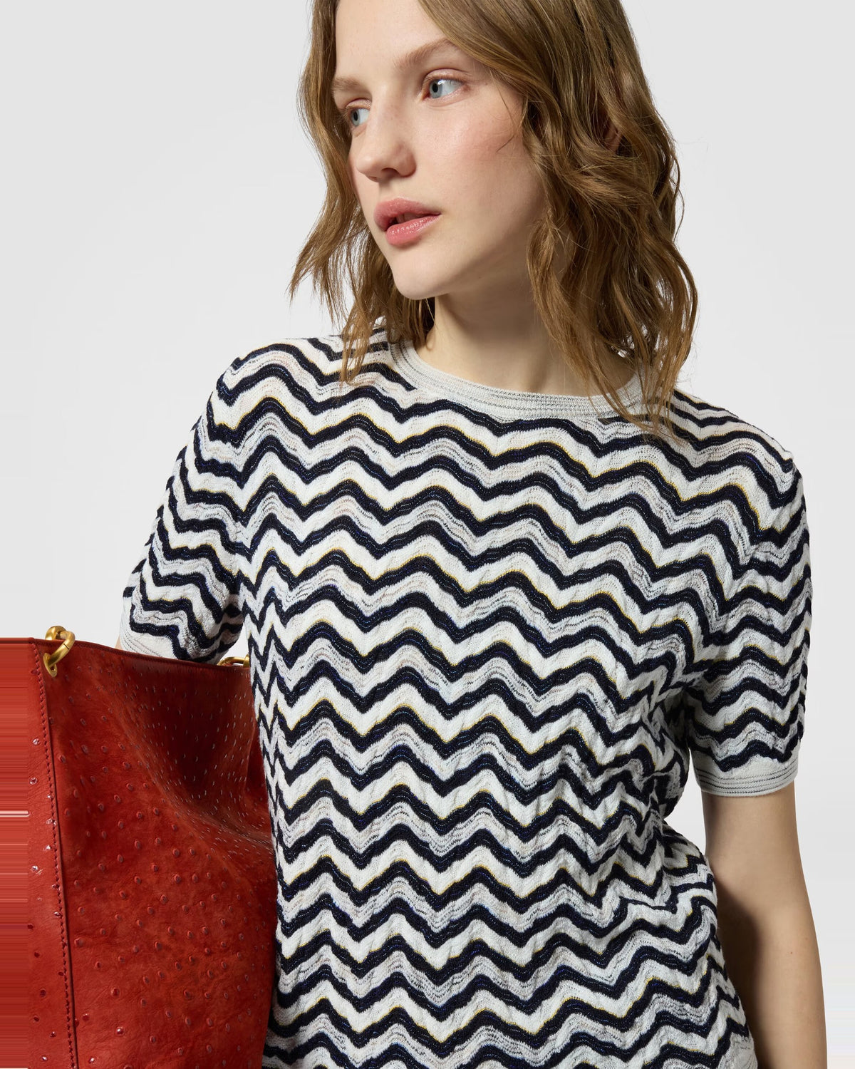 Close-up of the Missoni wave motif knit and ribbed crew neck on the navy and white short-sleeve top