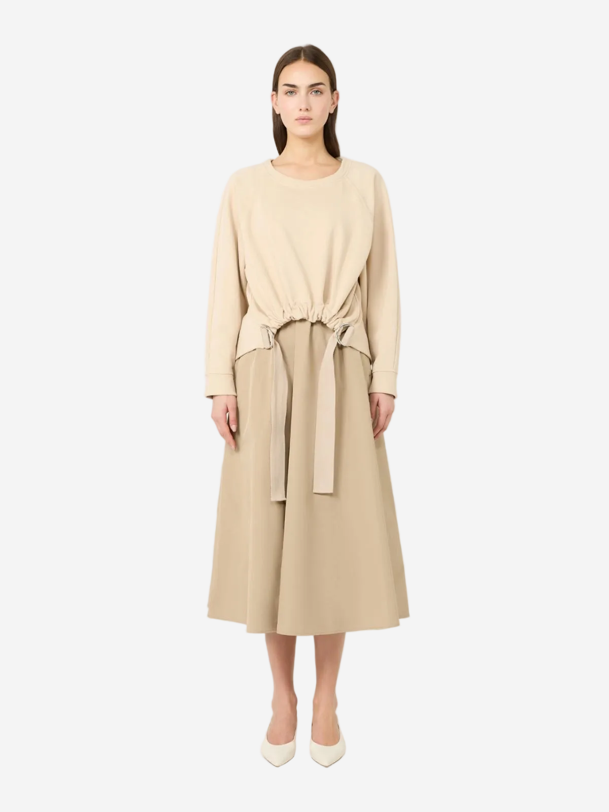 Woman wearing a beige dress with a belt on a white background