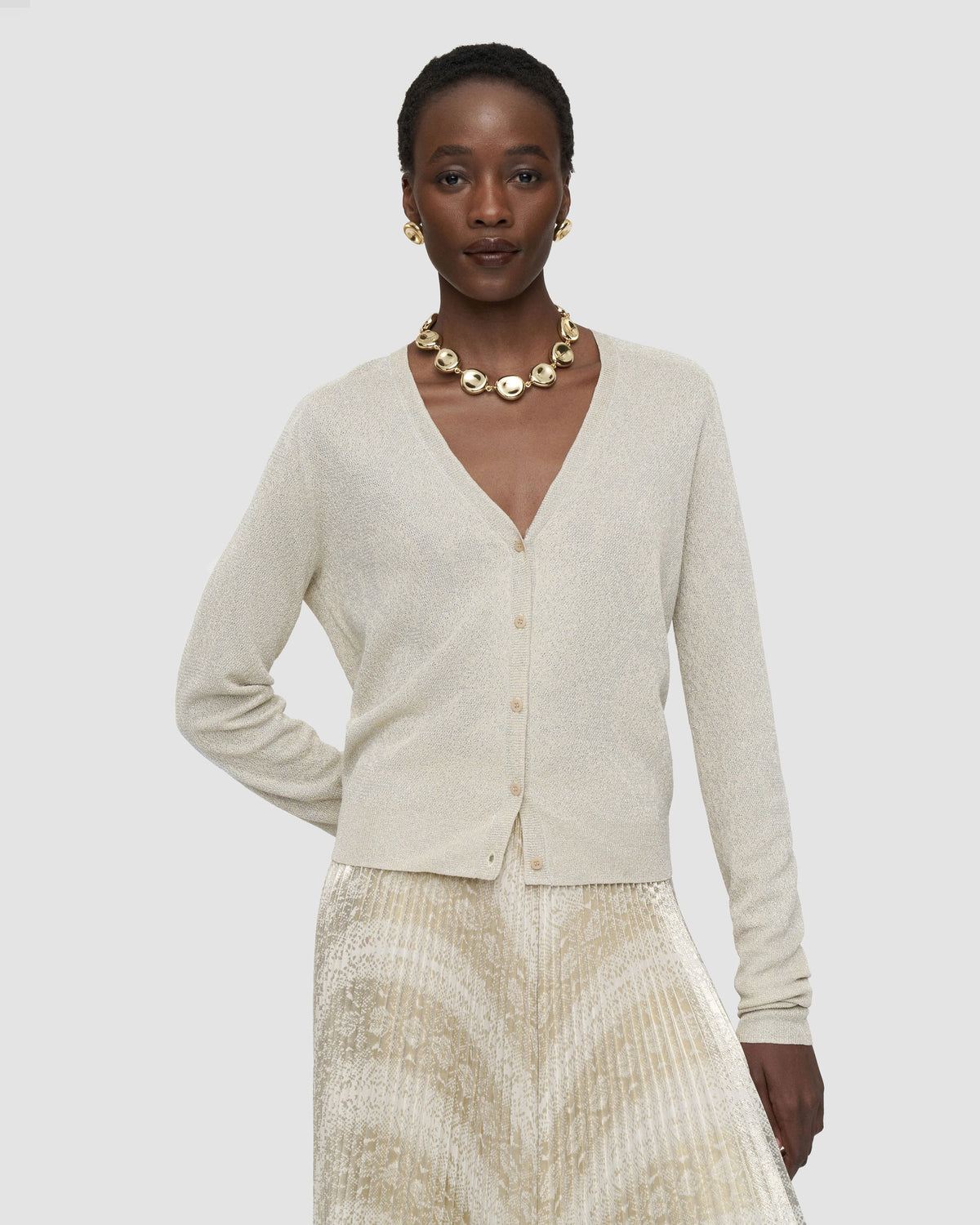 JOSEPH Doris metallic V-neck cardigan in champagne, styled with a pleated skirt at Christensen Copenhagen Sydney