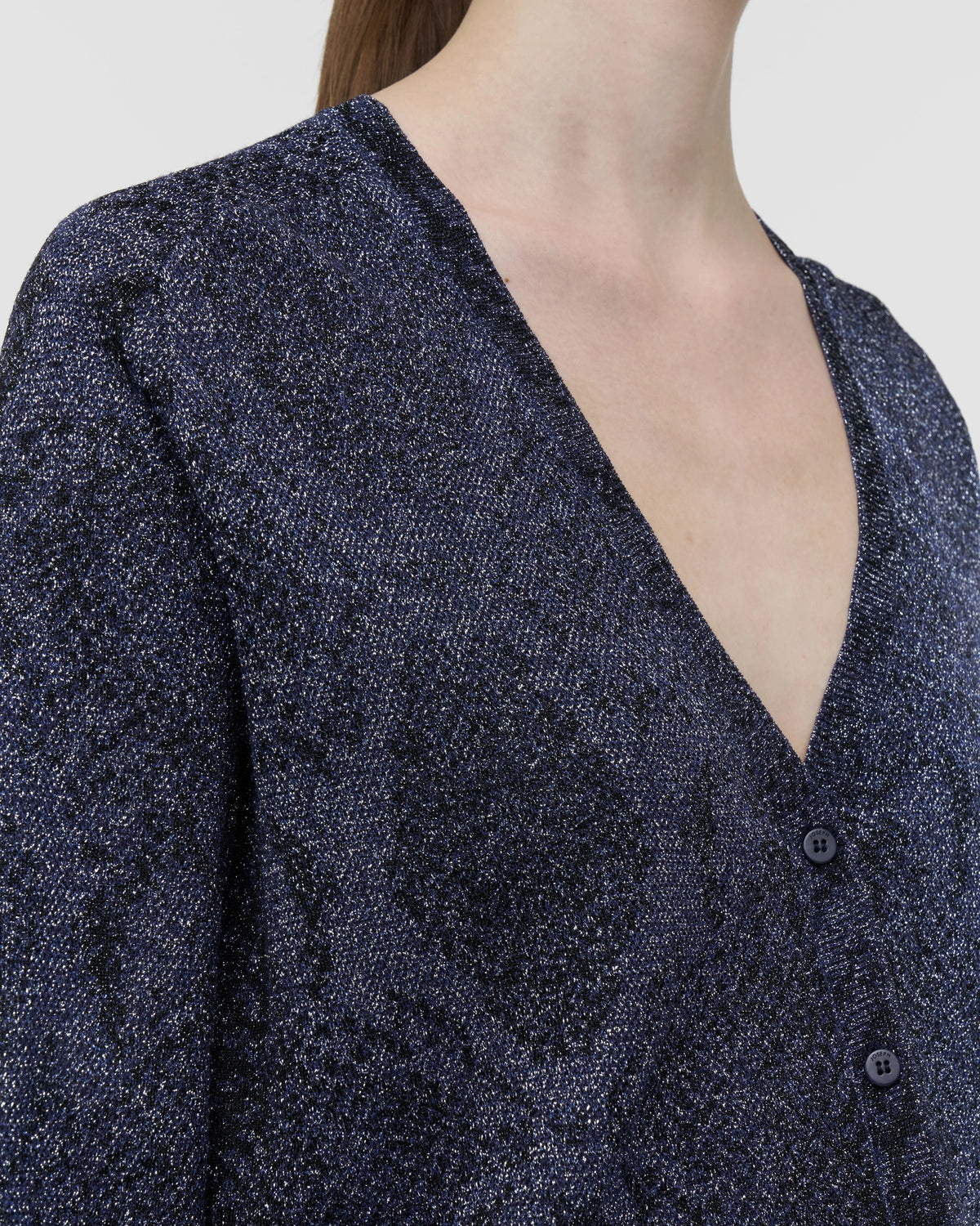 Close-up of the V-neck and shimmering navy metallic snake knit on the JOSEPH Doris cardigan