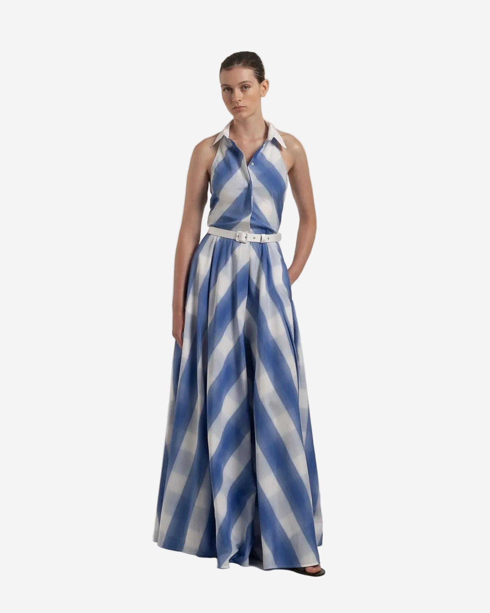 Woman wearing a blue and white striped dress on a plain background