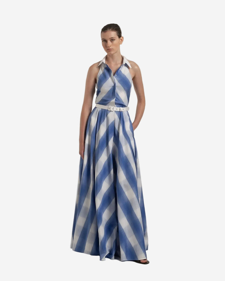 Woman wearing a blue and white striped dress on a plain background