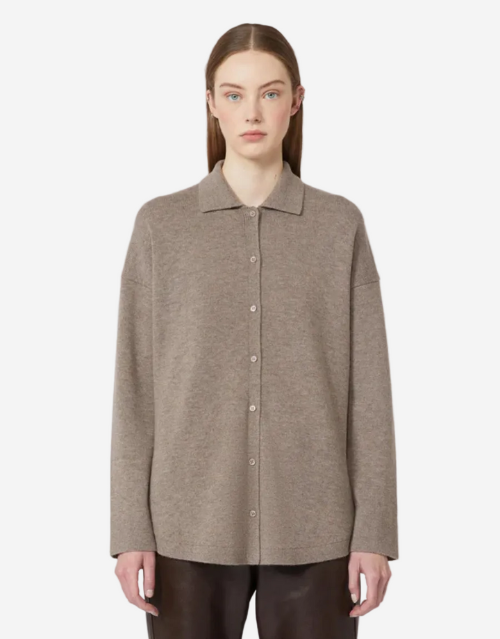 Woman wearing a brown button-up shirt on a white background