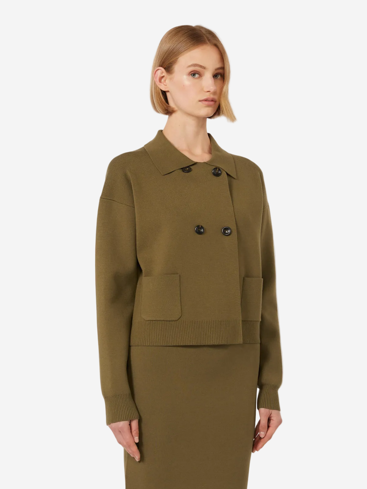 Woman wearing a green jacket and skirt set on a white background