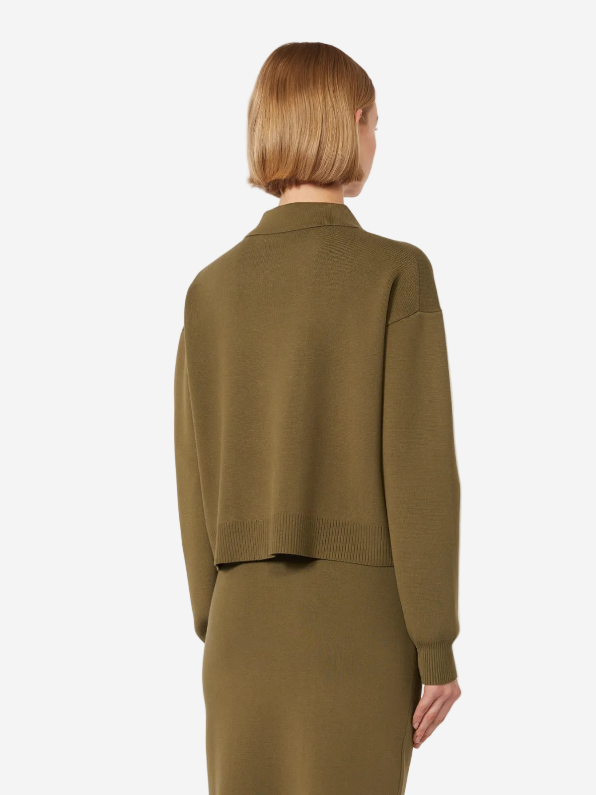 Person wearing a green outfit on a white background