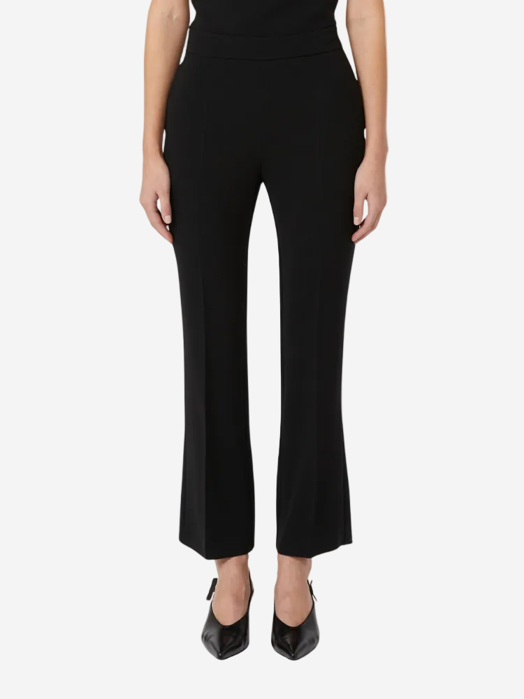 Person wearing black high-waisted pants on a white background
