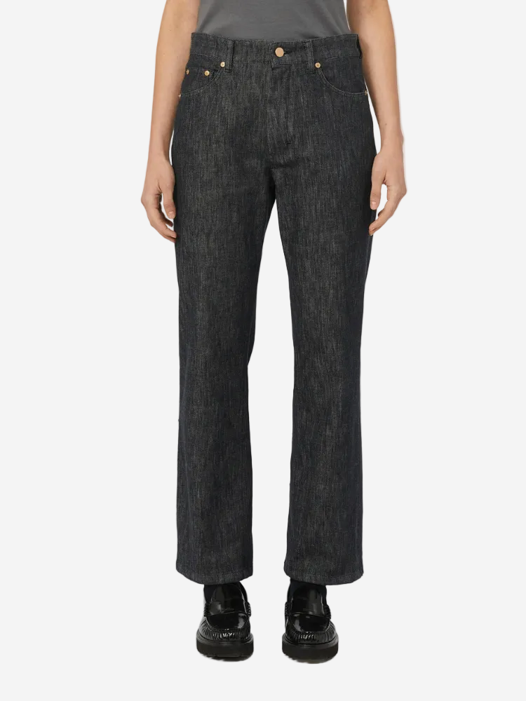 Person wearing black jeans on a white background