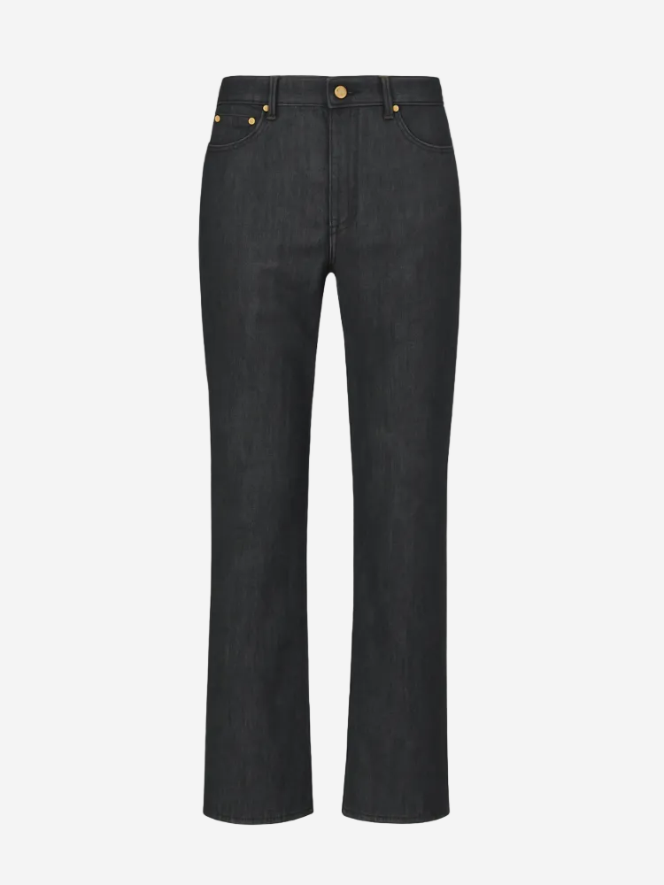 Black jeans with gold buttons on a white background
