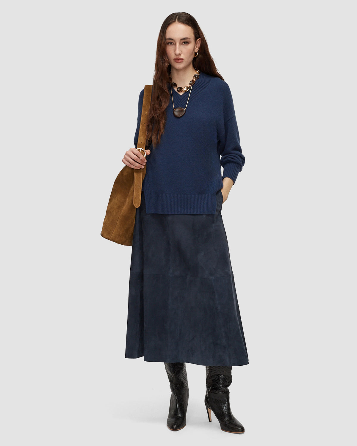 Model wearing a long blue leather suede skirt by Joseph.
