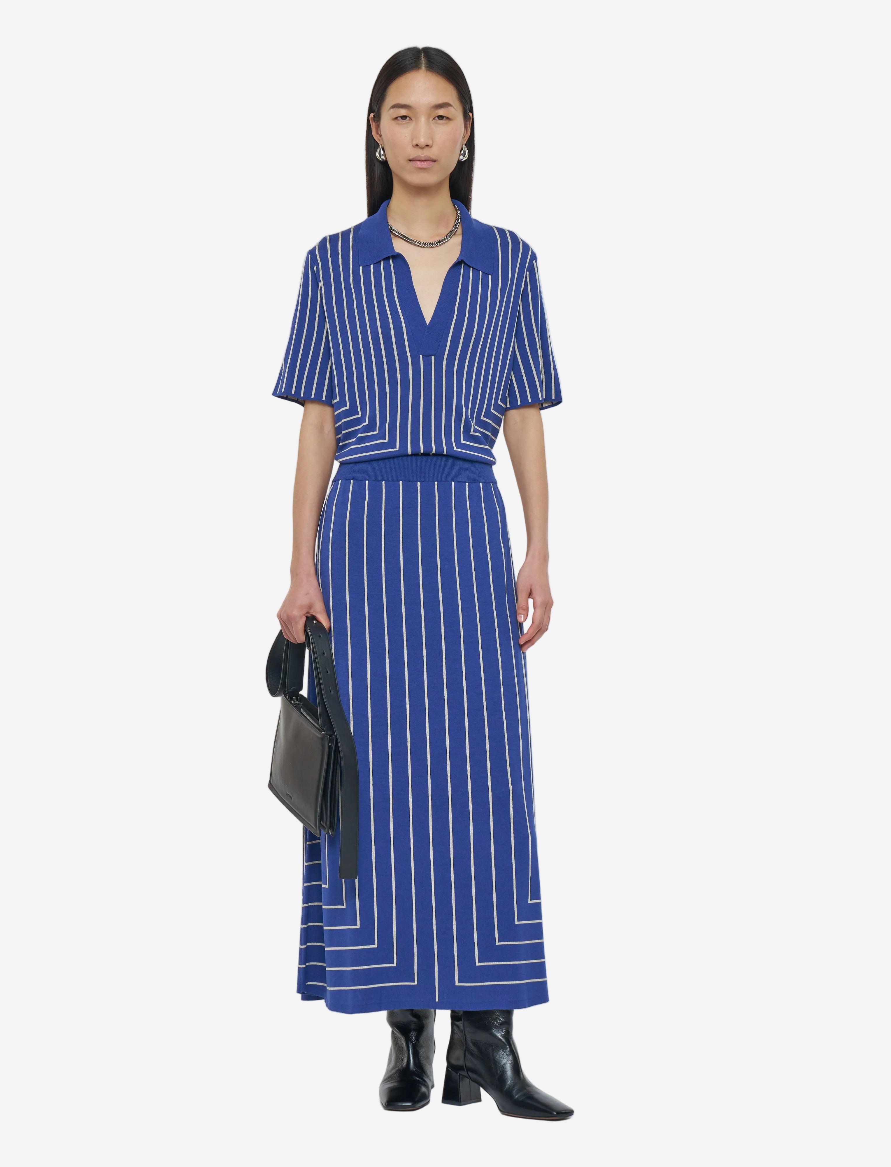Woman wearing a blue and white striped dress on a white background