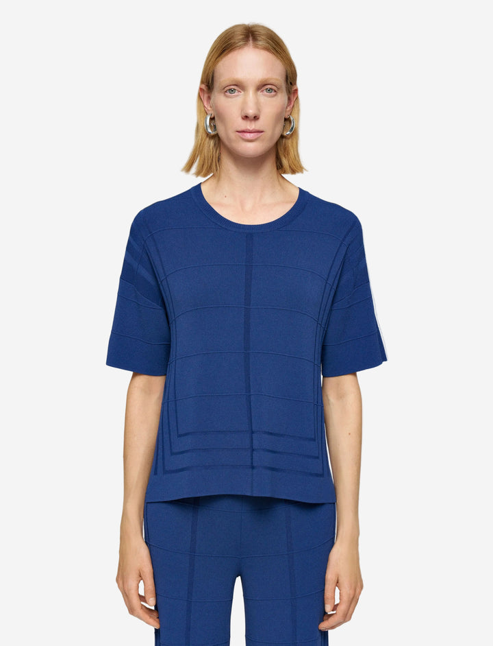 Woman wearing a blue outfit on a plain background