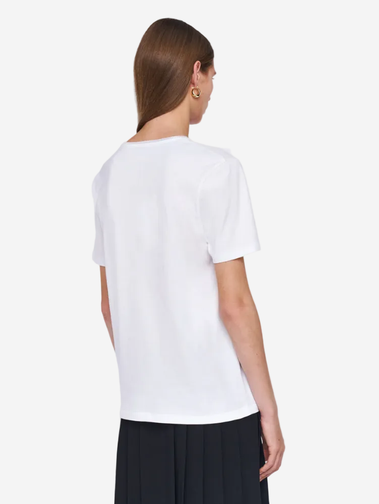 Person wearing a white t-shirt on a light gray background