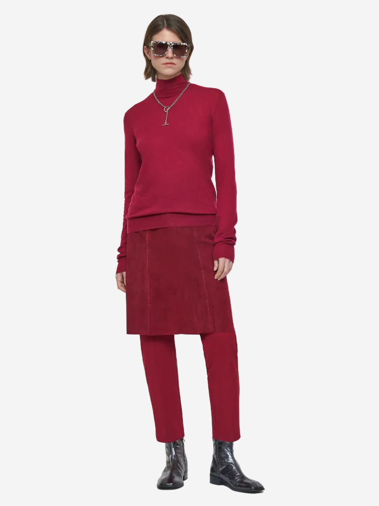 Person wearing a red outfit with sunglasses on a white background