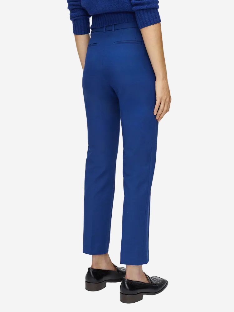 Blue pants worn by a person on a white background