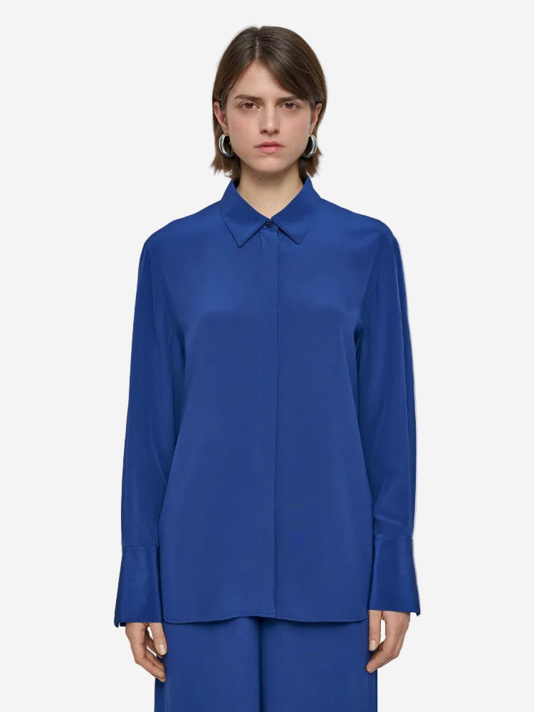 Person wearing a blue shirt on a plain background