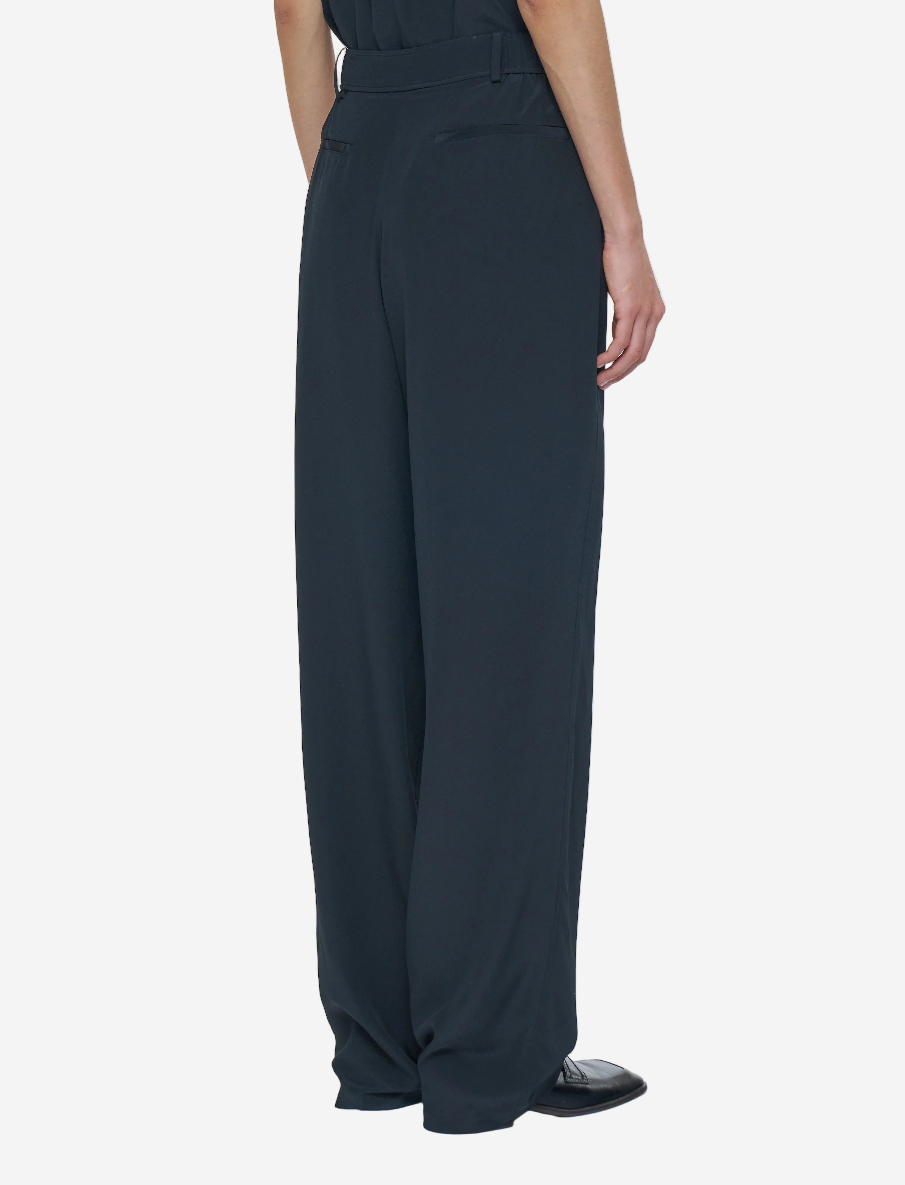 Black wide-leg pants worn by a person on a white background