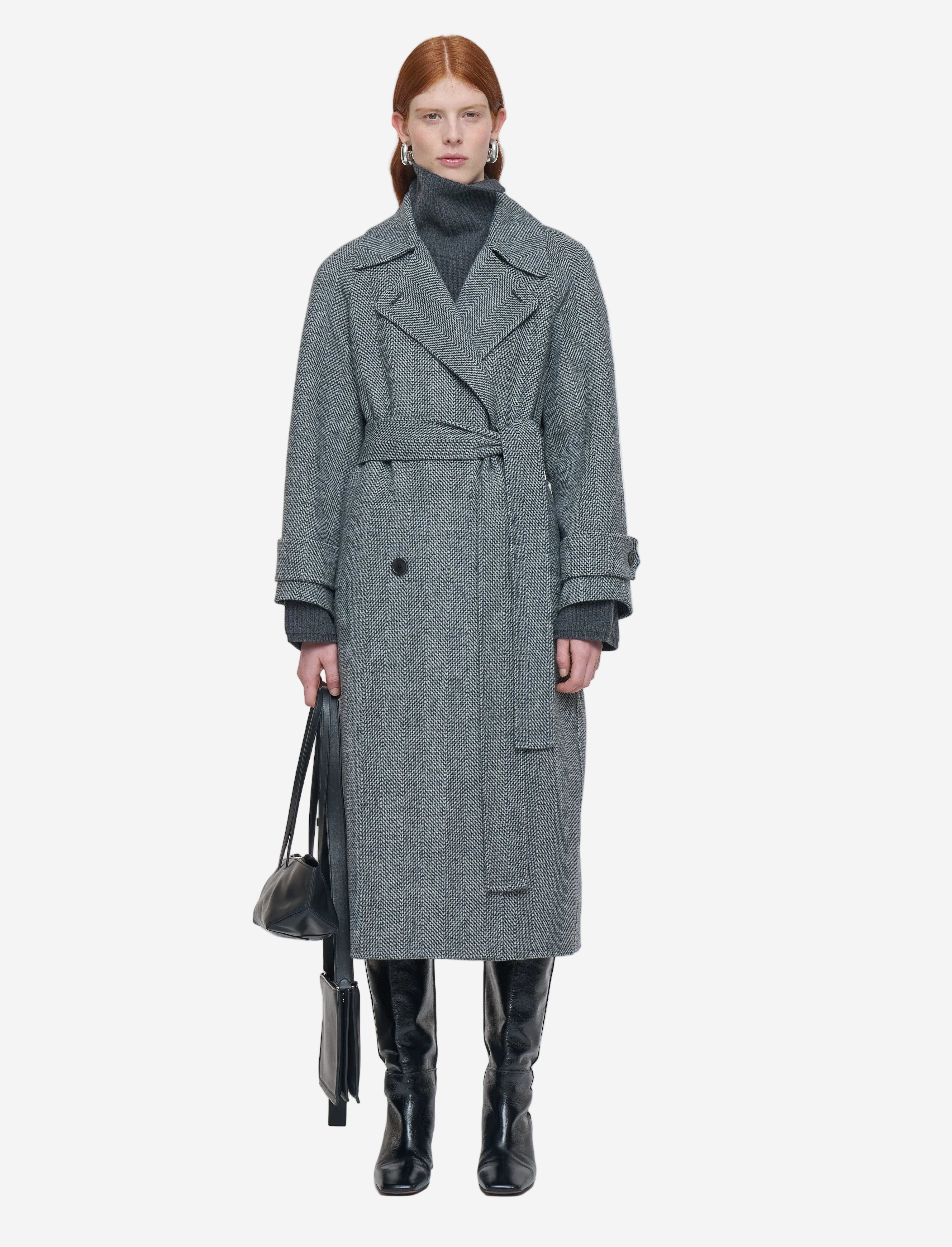 Person wearing a gray coat on a white background