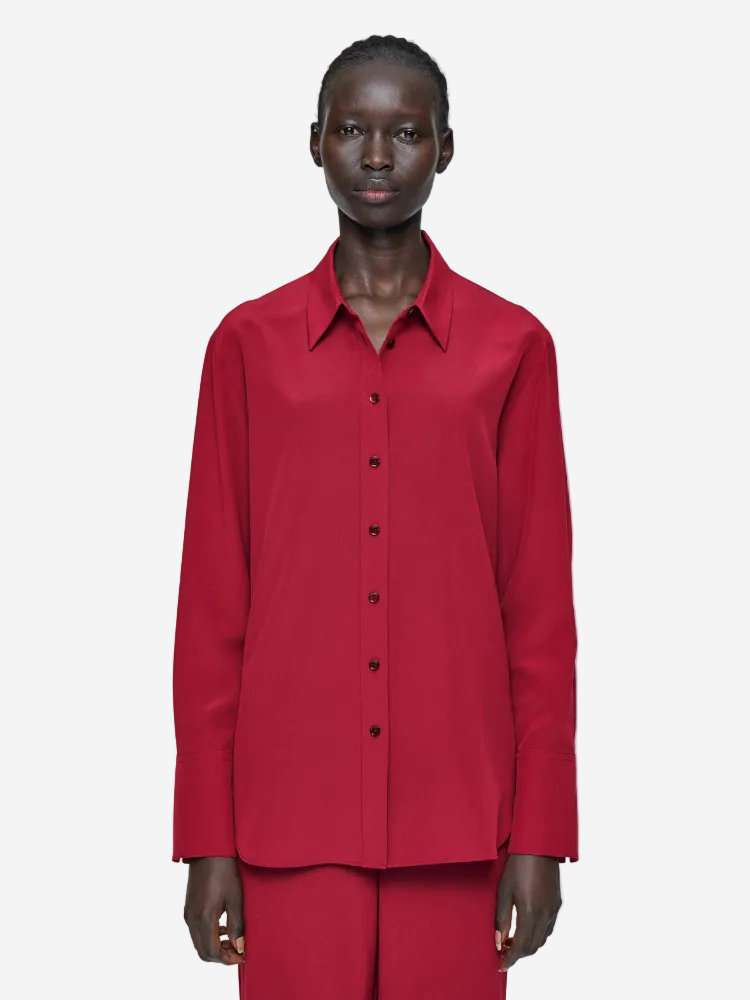Person wearing a red shirt and pants on a white background