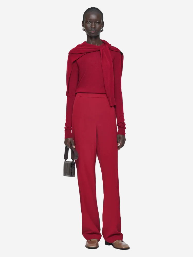 Person wearing a red outfit with a matching jacket on a white background
