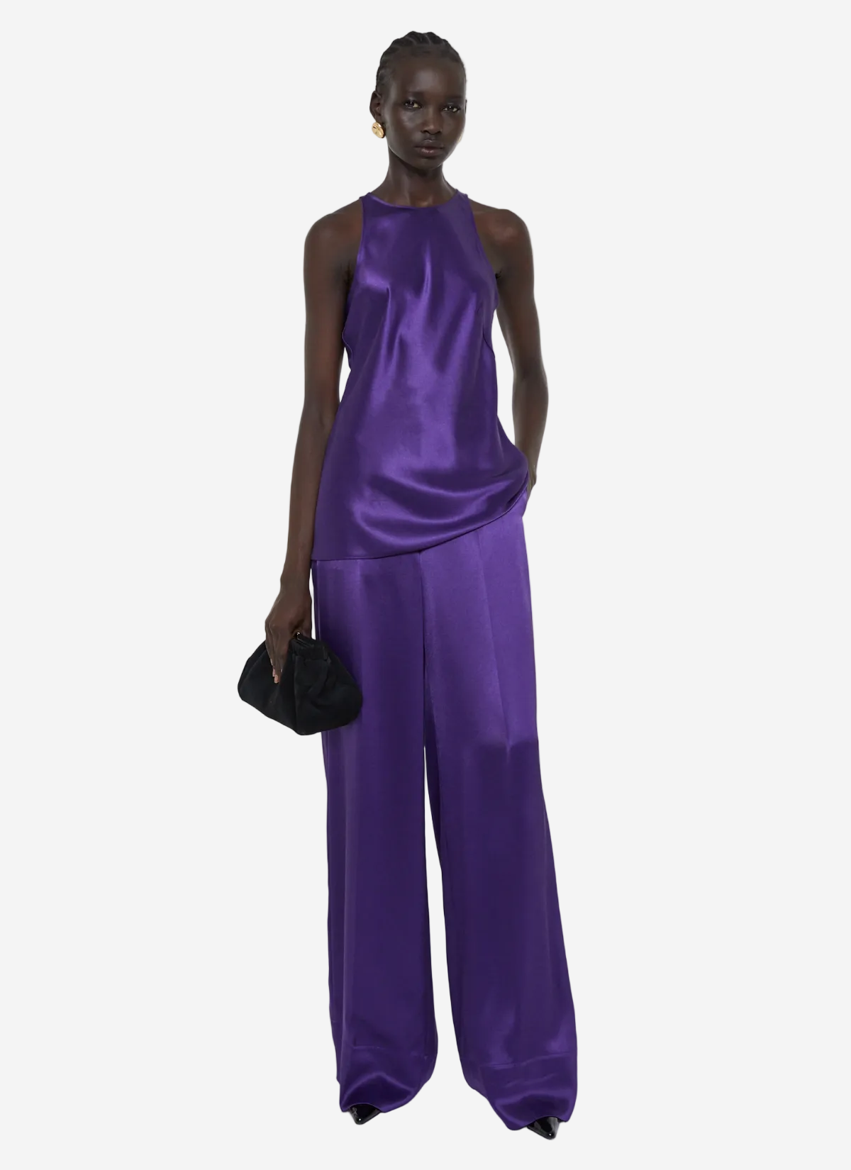 Woman wearing a purple satin jumpsuit on a white background