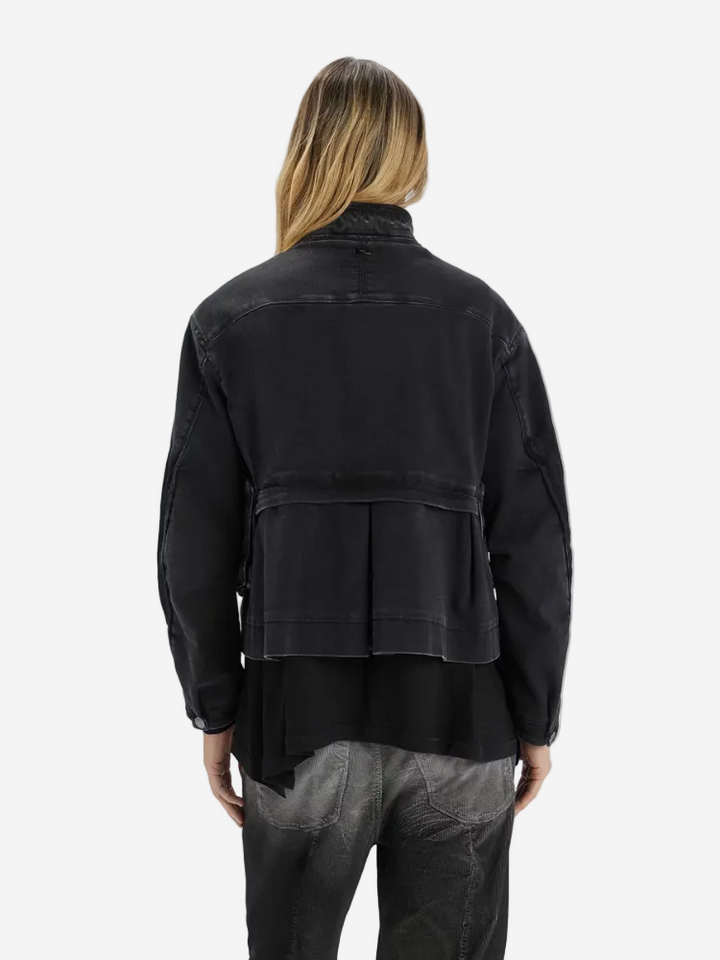 Person wearing a black jacket on a white background