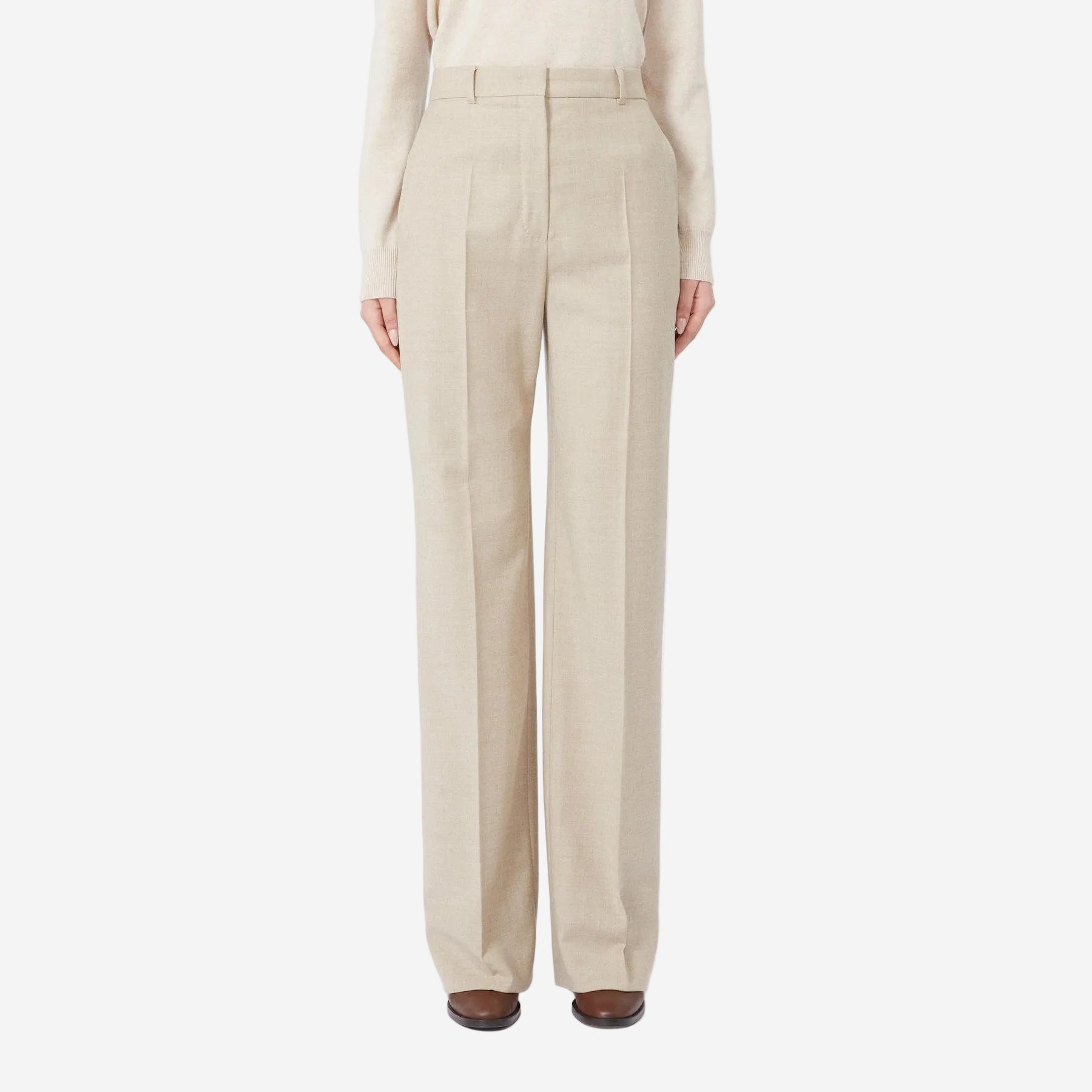 Beige pants worn by a person on a white background