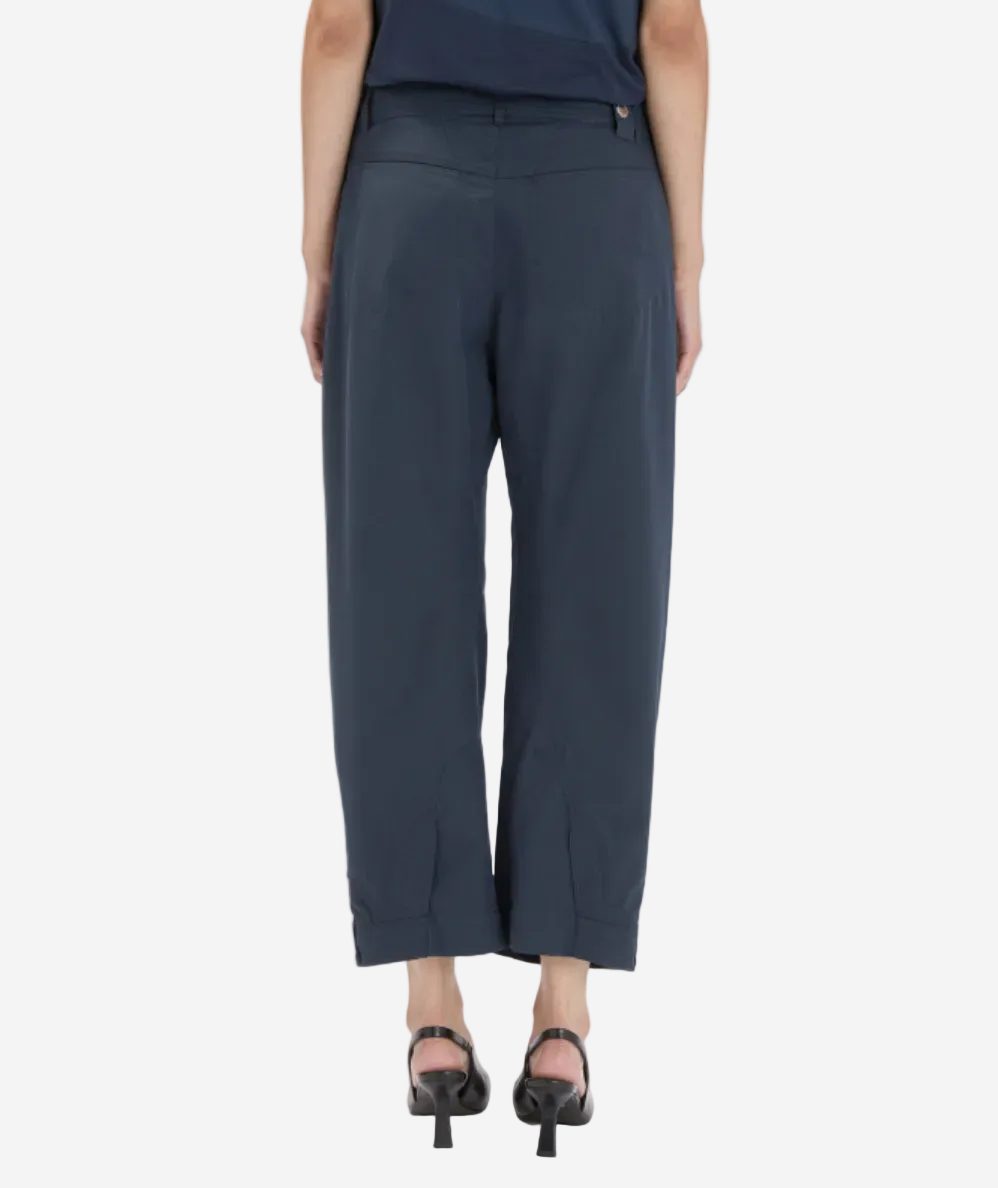 Person wearing navy blue pants on a white background
