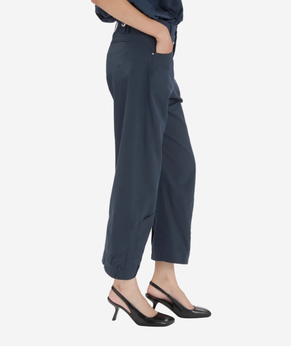 Person wearing dark gray pants on a white background