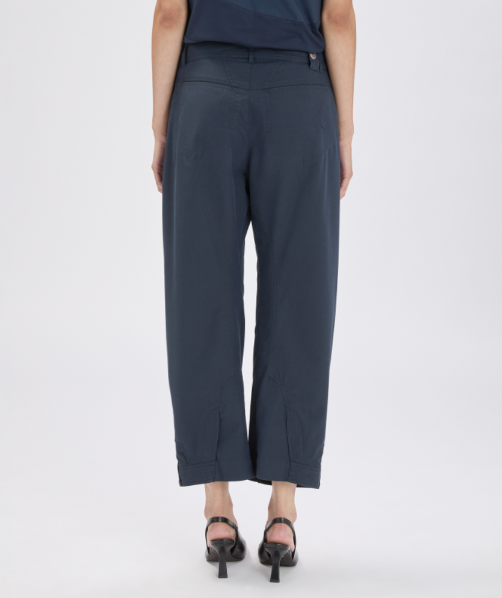 Person wearing navy blue pants on a white background