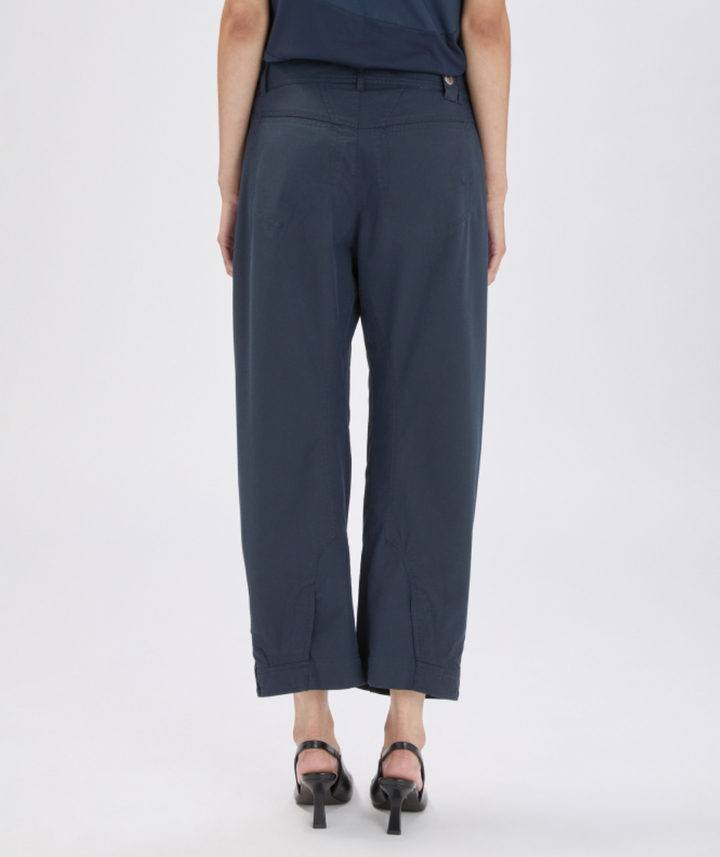 Person wearing navy blue pants on a white background