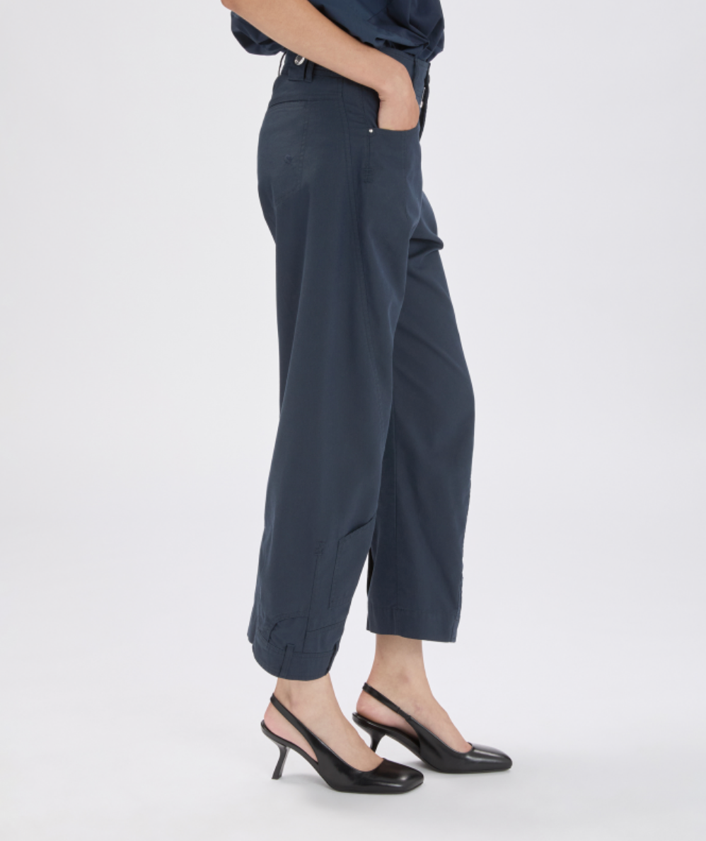 Person wearing dark gray pants on a white background