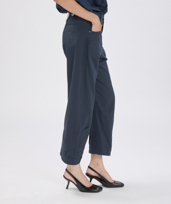 Person wearing dark gray pants on a white background
