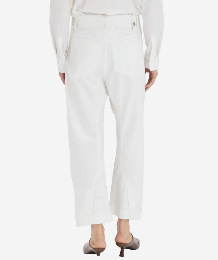 White pants worn by a person on a white background