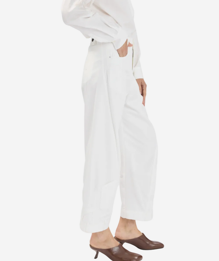 Person wearing a white outfit with a plain background