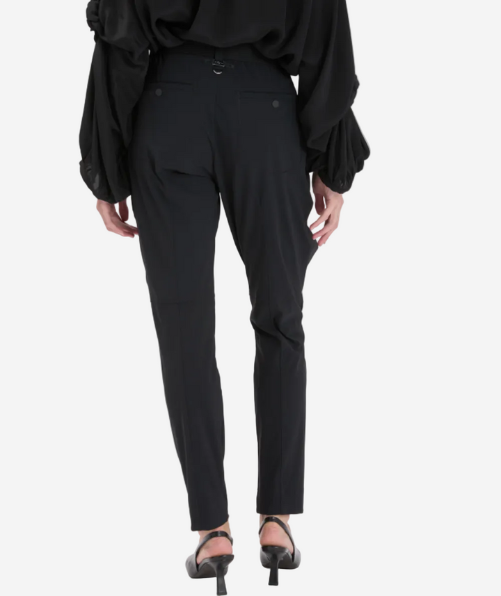Person wearing black pants and a black top on a white background