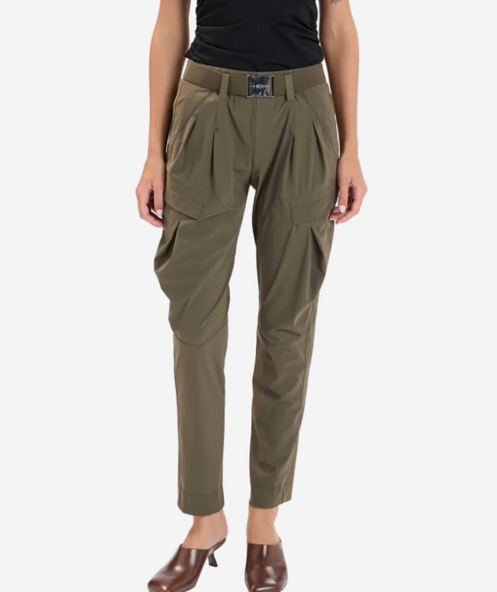 Person wearing olive green pants on a white background