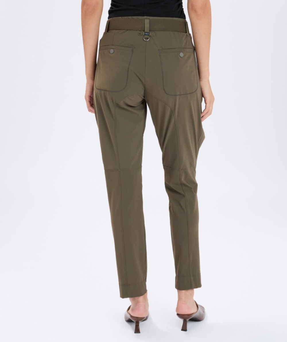 Olive green pants worn by a person on a white background